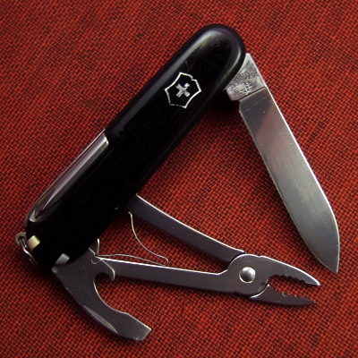 The Victorinox Mechanic Jr., also known as the "Special Mechanic", was manufactured for Radio Shack and marked as part of their "Techline" brand.  The top/obverse side has a metal inlay reading "Techline".